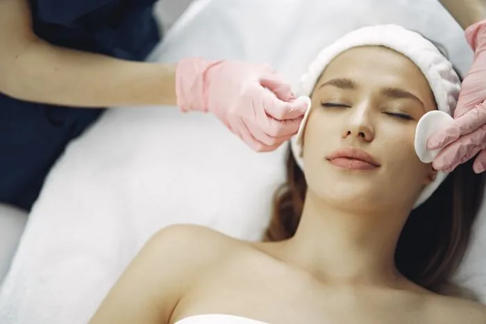 Beauty therapist giving a client a facial treatment
