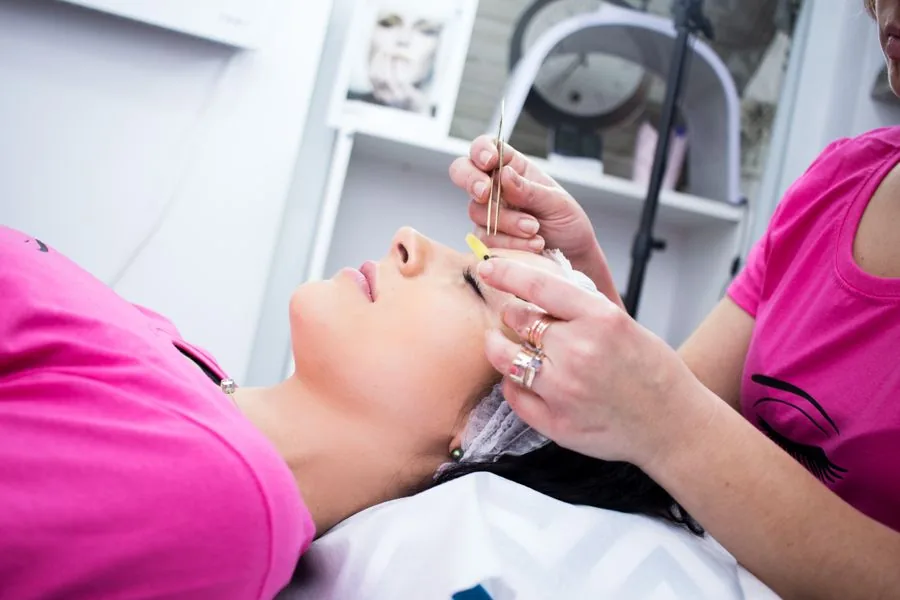 Client relaxing during a facial in a beauty salon
