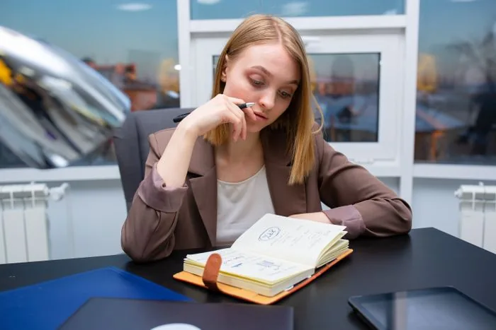 Business owner planning her exit strategy with a notebook at her desk